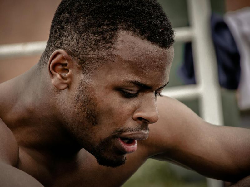 Close-up on a man's determined face during an exercise.